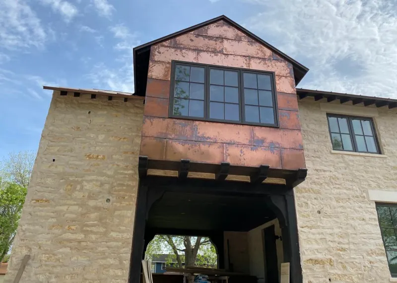 Copper metal panel facade on a stone building for Roof Repair in Palm Coast