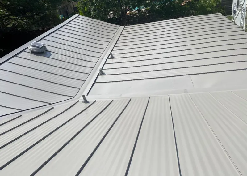 Solar attic fan installed on a metal roof for Roof Ventilation in Palm Coast